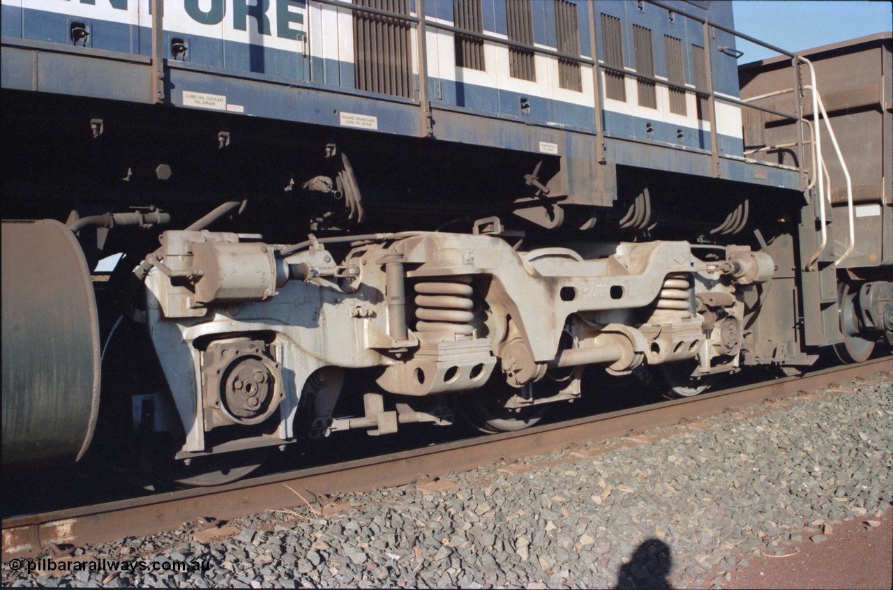 234-16
Yandi Two, BHP Iron Ore Goninan rebuild CM40-8M GE unit 5640 'Ethel Creek' serial 8281-05 / 92-129 is on the rear of a 240 waggon loaded train, this configuration was trialled for a time with two Dash 8 locos, 120 waggons, Dash 8, 120 waggons and Dash 8. View of left hand side rear bogie. Circa 1998.
Keywords: 5640;Goninan;GE;CM40-8M;8281-05/92-129;rebuild;AE-Goodwin;ALCo;M636C;5479;G6047-11;