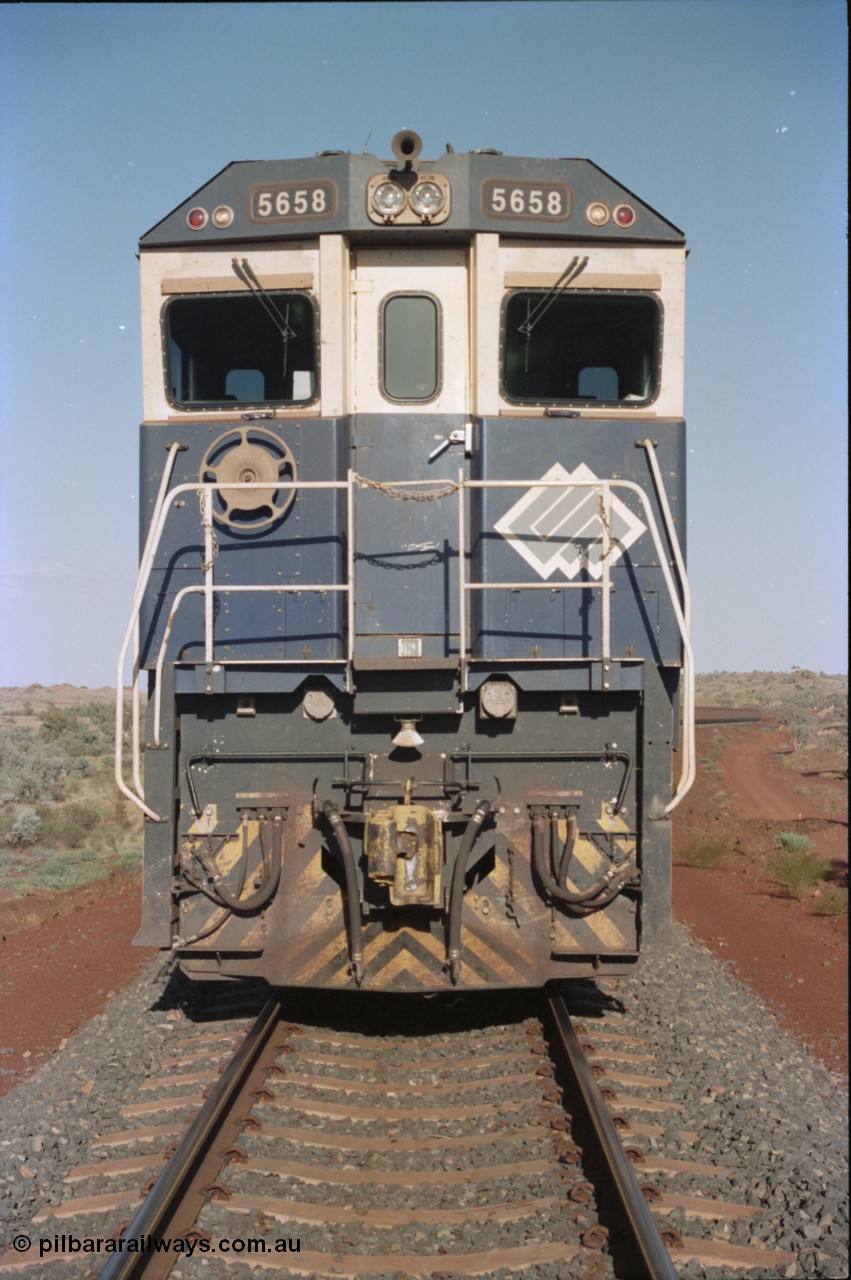 234-20
Yandi Two, BHP Iron Ore Goninan rebuild CM40-8M GE unit 5658 'Kakogawa' serial 8412-03 / 94-149 on the front of a 240 waggon loaded train, this configuration was trialled for a time with two Dash 8 locos, 120 waggons, Dash 8, 120 waggons and Dash 8. Cab front on view. Circa 1998.
Keywords: 5658;Goninan;GE;CM40-8M;8412-03/94-149;rebuild;AE-Goodwin;ALCo;M636C;5480;G6061-1;