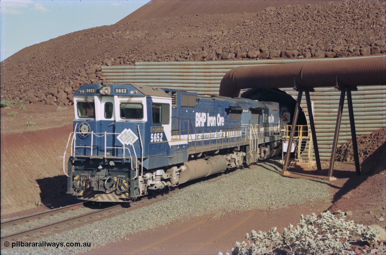 235-15
Yandi Two, BHP Iron Ore Goninan rebuild CM40-8M GE unit 5652 'Villanueva' serial 8412-09 / 93-143 leads the afternoon 240 waggon train with second unit Goninan built CM39-8 unit 5630 'Zeus' as the exit the loadout tunnel, notice the fuel tank differences between the lead unit an ALCo rebuild and the second unit built new.
Keywords: 5652;Goninan;GE;CM40-8M;8412-09/93-143;rebuild;AE-Goodwin;ALCo;M636C;5482;G6061-3;