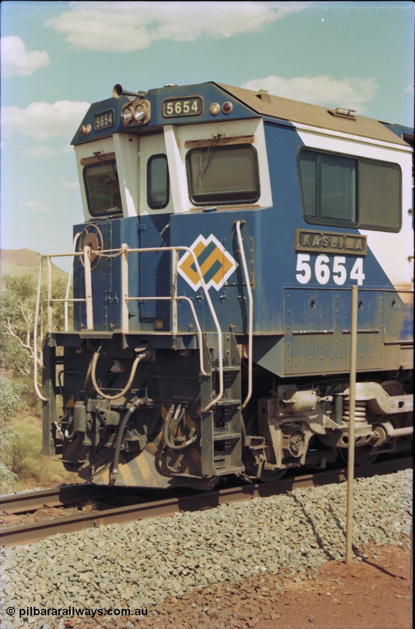 235-31
Yandi One, BHP Iron Ore Goninan rebuild CM40-8M GE unit 5654 'Kashima' serial 8412-11 / 93-145 sits on a loaded train awaiting departure time and also has the late marigold style BHP logo, cab side and Alco Hi-Ad bogie.
Keywords: 5654;Goninan;GE;CM40-8M;8412-11/93-145;rebuild;Comeng-NSW;ALCo;M636C;5493;C6084-9;