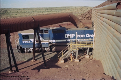 235-14
Yandi Two, BHP Iron Ore Goninan rebuild CM40-8M GE unit 5652 'Villanueva' serial 8412-09 / 93-143 passes out the other side of the loadout tunnel as loading has commenced, the dust extraction equipment and retaining wall culvert frame the loco.
Keywords: 5652;Goninan;GE;CM40-8M;8412-09/93-143;rebuild;AE-Goodwin;ALCo;M636C;5482;G6061-3;