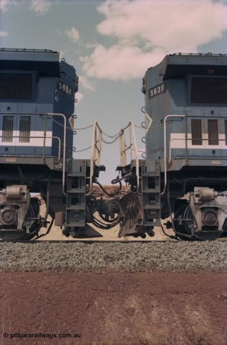 235-25
Yandi One, BHP Iron Ore Goninan rebuild CM40-8M GE unit 5654 'Kashima' serial 8412-11 / 93-145 on the left coupled to Goninan GE rebuild 5639 'Corunna Downs' serial 8281-03 / 92-128 on the right, note the differences in the two locos as 5653 is a later rebuild with marker lights and the marigold logo while 5639 has no marker lights, plain logo and a plough fitted to the No.2 end.
