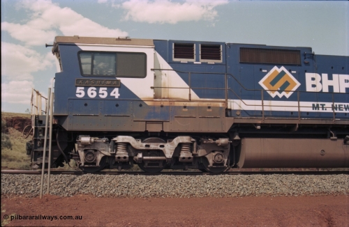 235-28
Yandi One, BHP Iron Ore Goninan rebuild CM40-8M GE unit 5654 'Kashima' serial 8412-11 / 93-145 sits on a loaded train awaiting departure time and also has the late marigold style BHP logo, cab side and Alco Hi-Ad bogie.
Keywords: 5654;Goninan;GE;CM40-8M;8412-11/93-145;rebuild;Comeng-NSW;ALCo;M636C;5493;C6084-9;