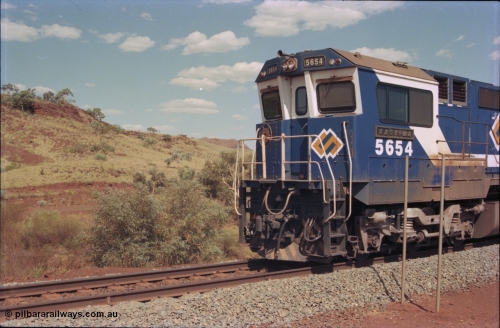 235-33
Yandi One, BHP Iron Ore Goninan rebuild CM40-8M GE unit 5654 'Kashima' serial 8412-11 / 93-145 sits on a loaded train awaiting departure time and also has the late marigold style BHP logo, cab side and Alco Hi-Ad bogie.
Keywords: 5654;Goninan;GE;CM40-8M;8412-11/93-145;rebuild;Comeng-NSW;ALCo;M636C;5493;C6084-9;