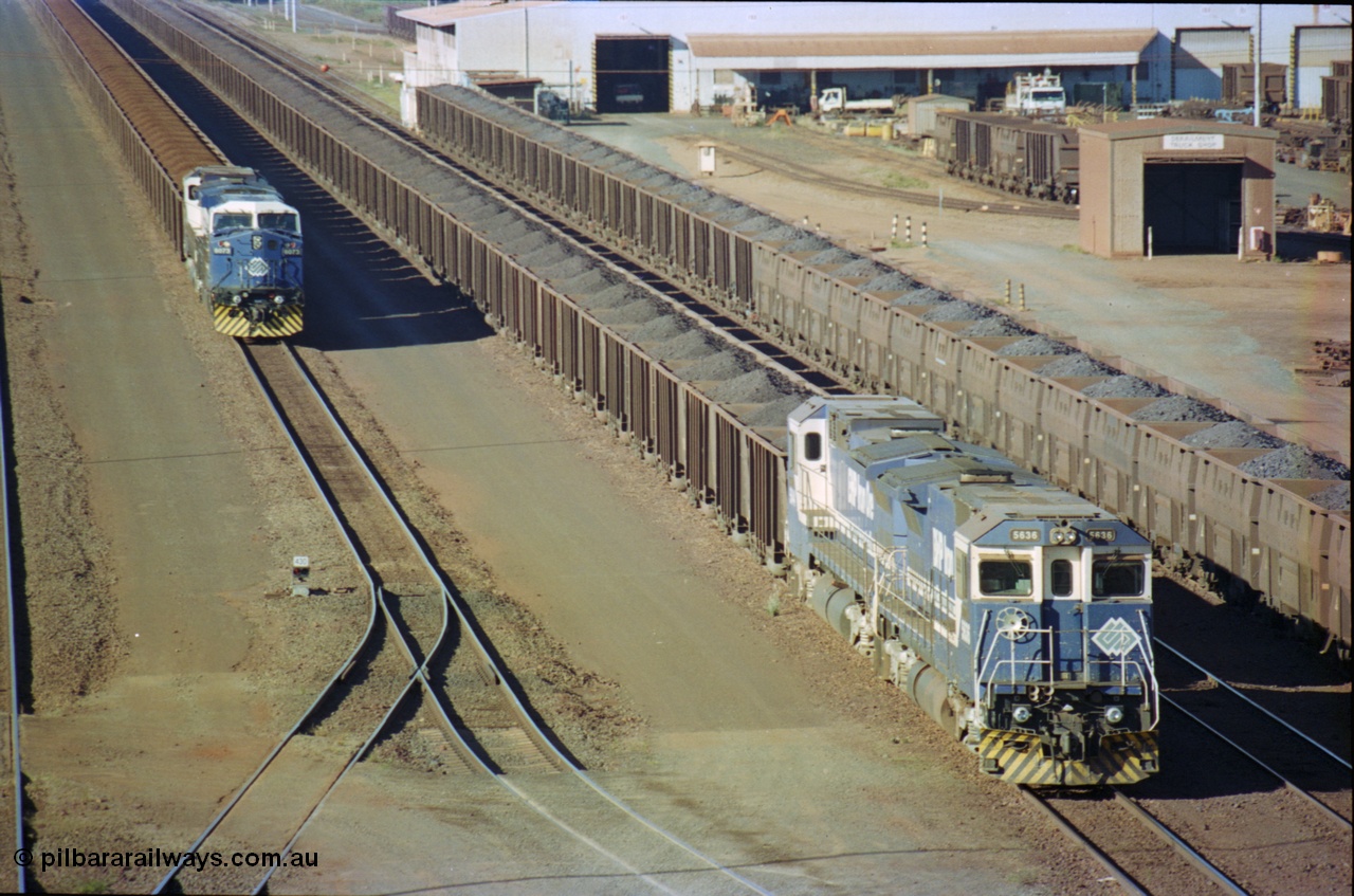 236-13
Nelson Point, Car Dumper Two delivery roads, BHP Dash 8 class locomotive 5636 'Munda', a Goninan 1991 rebuild to GE CM40-8M model, serial 8151-11 / 91-122 with a sister unit await to dump their train of Comeng style waggons, next to them is a string of Golynx style waggons and on the left sits an AC6000 6073 with a Dash 8 awaiting access to Car Dumper Three. The Ore Car Repair Shop is on the right.
Keywords: 5636;Goninan;GE;CM40-8M;8151-11/91-122;rebuild;AE-Goodwin;ALCo;C636;5462;G6035-3;