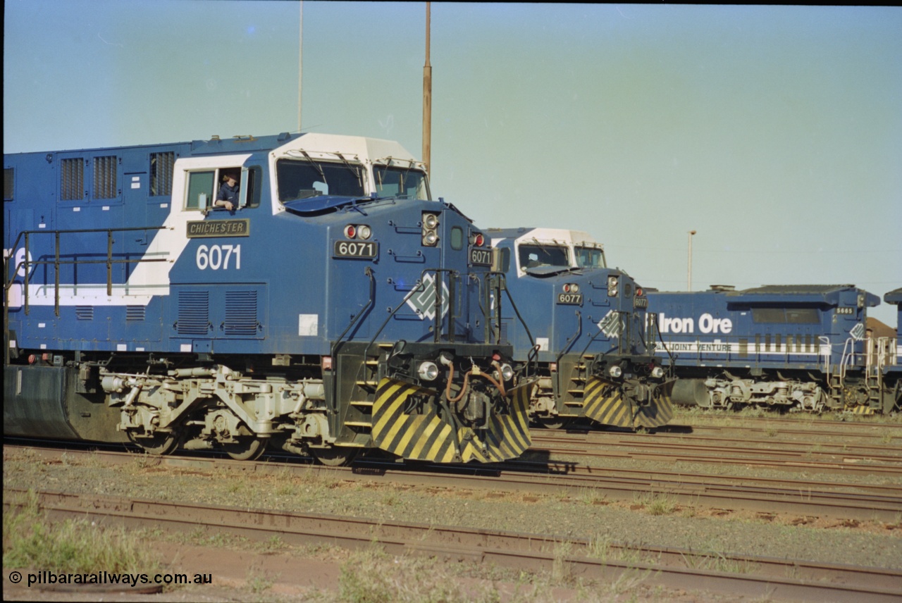 236-30
Nelson Point Loco Overhaul Shop, BHP Iron Ore's General Electric built AC6000 unit 6071 'Chichester' serial 51063 sits out the front with new windscreen protectors or 'blinkers' fitted next to sister unit 6077.
Keywords: 6071;GE;AC6000;51063;