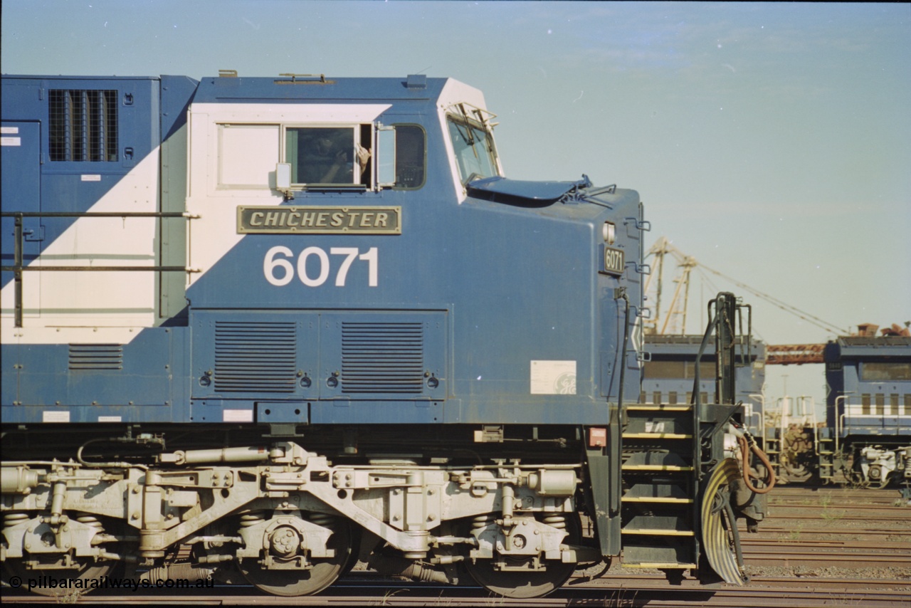 236-36
Nelson Point Loco Overhaul Shop, BHP Iron Ore's General Electric built AC6000 unit 6071 'Chichester' serial 51063 sits out the front with new windscreen protectors or 'blinkers' fitted, cab side and bogie view.
Keywords: 6071;GE;AC6000;51063;