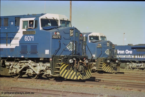 236-31
Nelson Point Loco Overhaul Shop, BHP Iron Ore's General Electric built AC6000 unit 6071 'Chichester' serial 51063 sits out the front with new windscreen protectors or 'blinkers' fitted next to sister unit 6077.
Keywords: 6071;GE;AC6000CW;51063;
