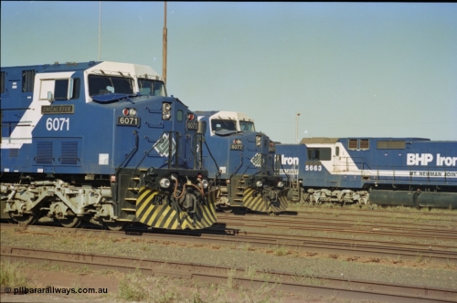 236-32
Nelson Point Loco Overhaul Shop, BHP Iron Ore's General Electric built AC6000 unit 6071 'Chichester' serial 51063 sits out the front with new windscreen protectors or 'blinkers' fitted next to sister unit 6077.
Keywords: 6071;GE;AC6000CW;51063;
