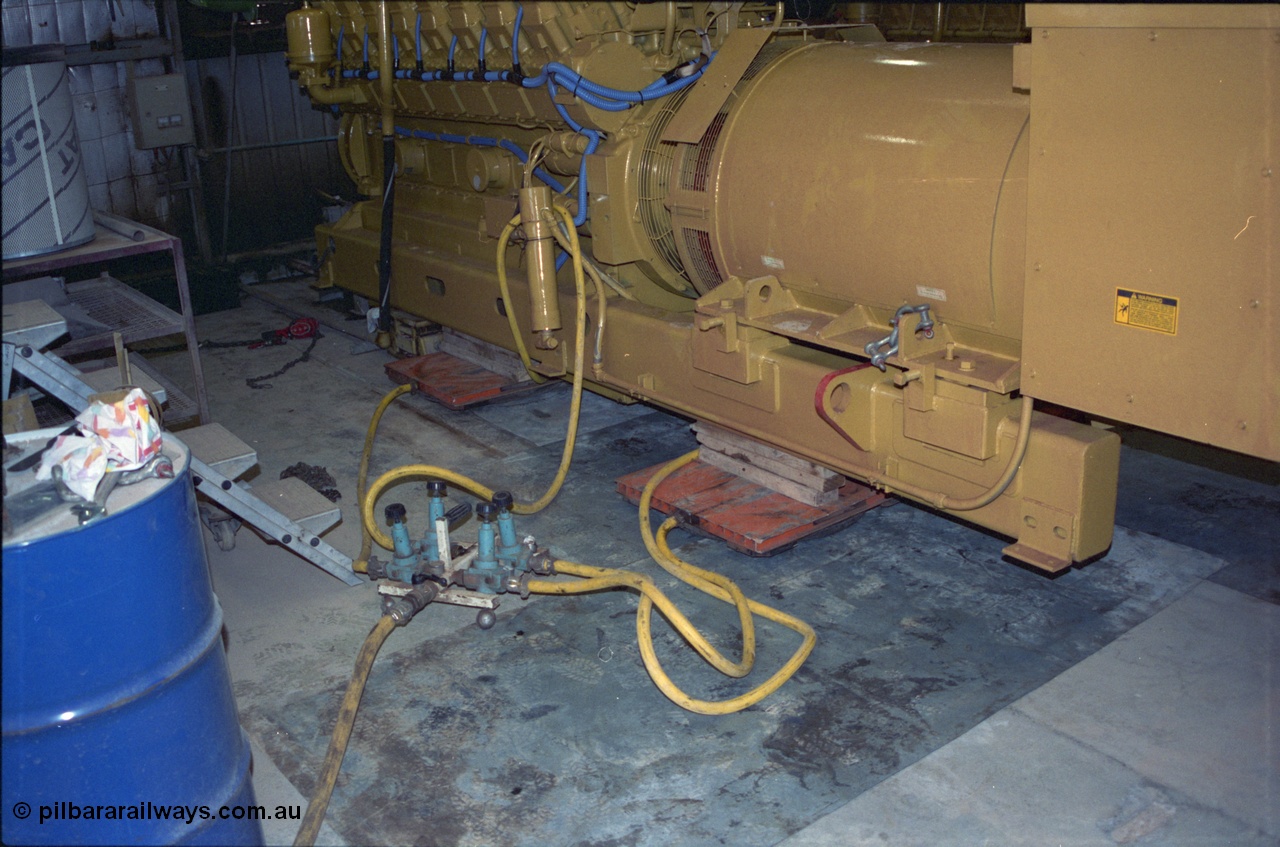 239-01
View inside the diesel power station located at Yandi One of a freshly overhauled Caterpillar 3516 engine and Kato alternator. Genset no. 1. Shows the air operated skate system to manoeuvre the unit into position. [url=https://goo.gl/maps/Vj93nhEZgdQ2]GeoData[/url].
Keywords: 3516;Caterpillar;