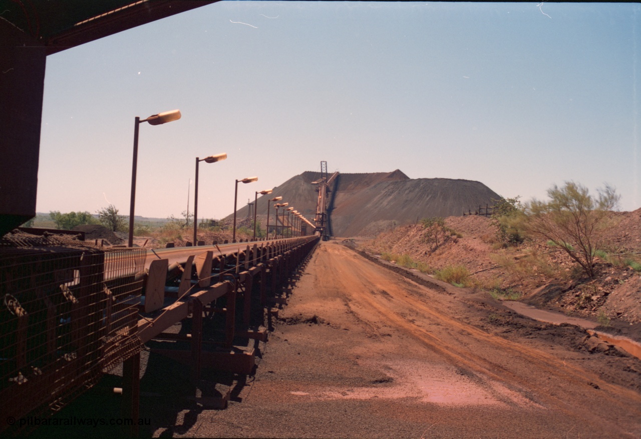 239-11
Overview of Yandi One looking towards the stockpile along CV11 towards CV20 and the radial stacker and CV21 the boom conveyor and full stockpile indicating the impending arrival of a train. The steel laydown is visible on the right. [url=https://goo.gl/maps/AL4aLqyaDJH2]GeoData[/url].
