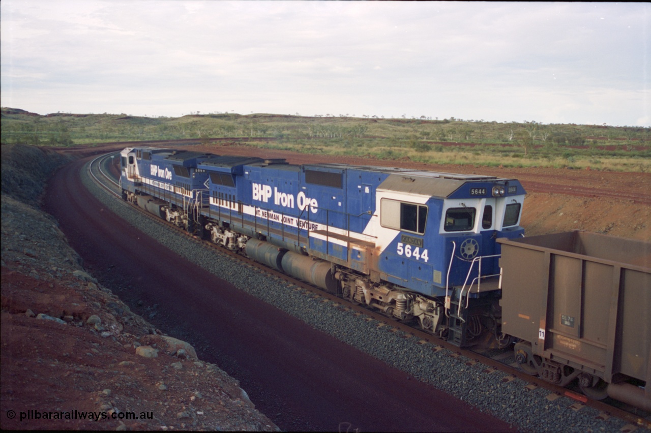 239-36
Yandi Two, train loading is under way with a pair of Goninan rebuild units, CM40-8MEFI unit 5668 'Dunkirk' serial 8412-01/95-159 and CM40-8M unit 5644 'Kangan' serial 8281-09/92-133. The lead unit was originally Comeng NSW built ALCo M636 5489 serial C6084-5, while second unit 5644 was originally a AE Goodwin built ALCo M636 5471 serial G6047-3.
