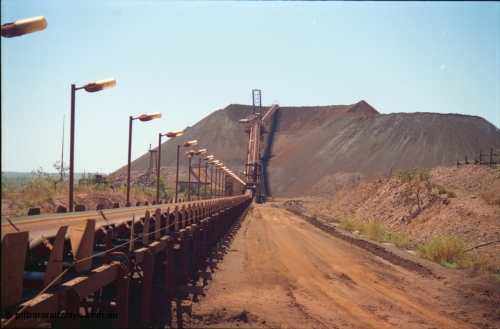 239-12
Overview of Yandi One looking towards the stockpile along CV11 towards CV20 and the radial stacker and CV21 the boom conveyor and full stockpile indicating the impending arrival of a train. The steel laydown is visible on the right. [url=https://goo.gl/maps/AL4aLqyaDJH2]GeoData[/url].
