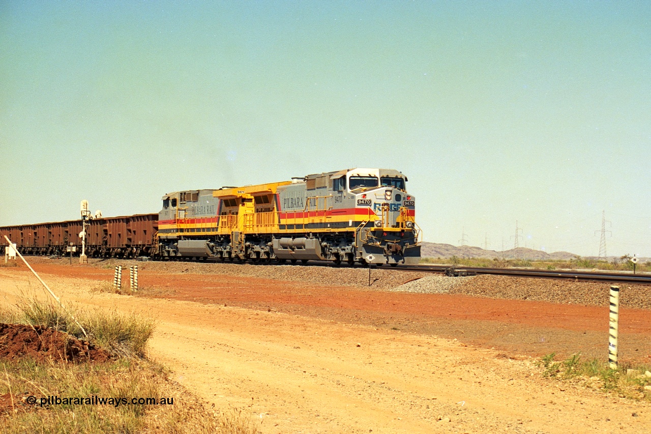 240-26
Seven Mile, loaded train heading for Parker Point behind a pair of Pilbara Rail, Robe River owned, General Electric built Dash 9-44CW units 9470 serial 53455 and 9471 serial 53456. These and sister unit 9472 were the first painted in the Pilbara Rail livery. 31st August 2002.
Keywords: 9470;9471;GE;Dash-9-44CW;53455;53456;