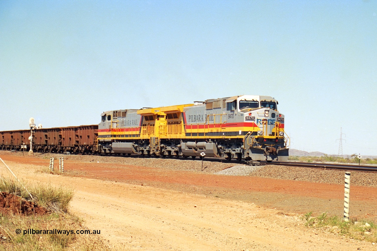 240-27
Seven Mile, loaded train heading for Parker Point behind a pair of Pilbara Rail, Robe River owned, General Electric built Dash 9-44CW units 9470 serial 53455 and 9471 serial 53456. These and sister unit 9472 were the first painted in the Pilbara Rail livery. 31st August 2002.
Keywords: 9470;9471;GE;Dash-9-44CW;53455;53456;