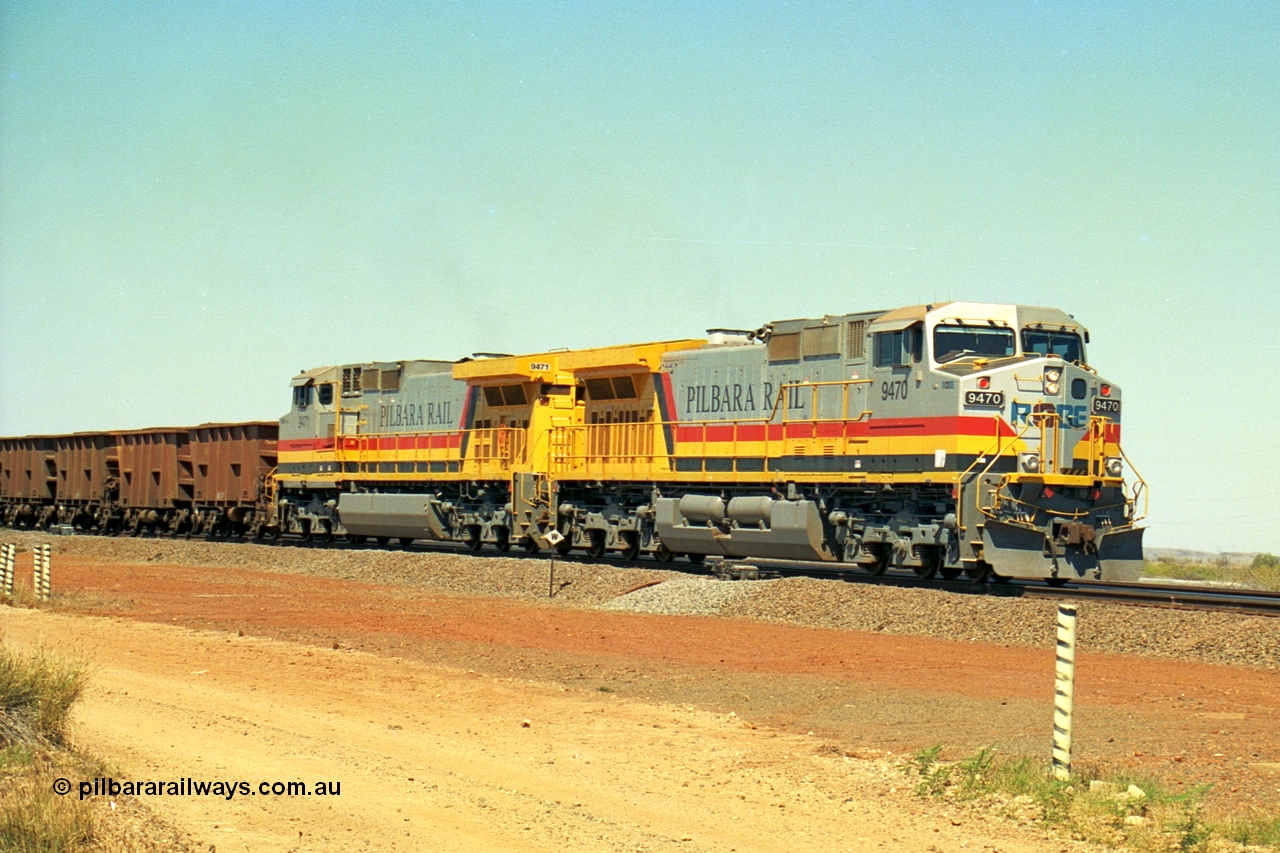 240-28
Seven Mile, loaded train heading for Parker Point behind a pair of Pilbara Rail, Robe River owned, General Electric built Dash 9-44CW units 9470 serial 53455 and 9471 serial 53456. These and sister unit 9472 were the first painted in the Pilbara Rail livery. 31st August 2002.
Keywords: 9470;9471;GE;Dash-9-44CW;53455;53456;