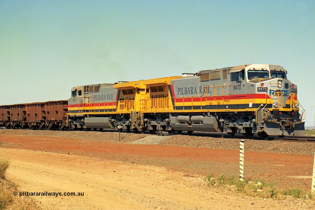 240-29
Seven Mile, loaded train heading for Parker Point behind a pair of Pilbara Rail, Robe River owned, General Electric built Dash 9-44CW units 9470 serial 53455 and 9471 serial 53456. These and sister unit 9472 were the first painted in the Pilbara Rail livery. 31st August 2002.
Keywords: 9470;9471;GE;Dash-9-44CW;53455;53456;