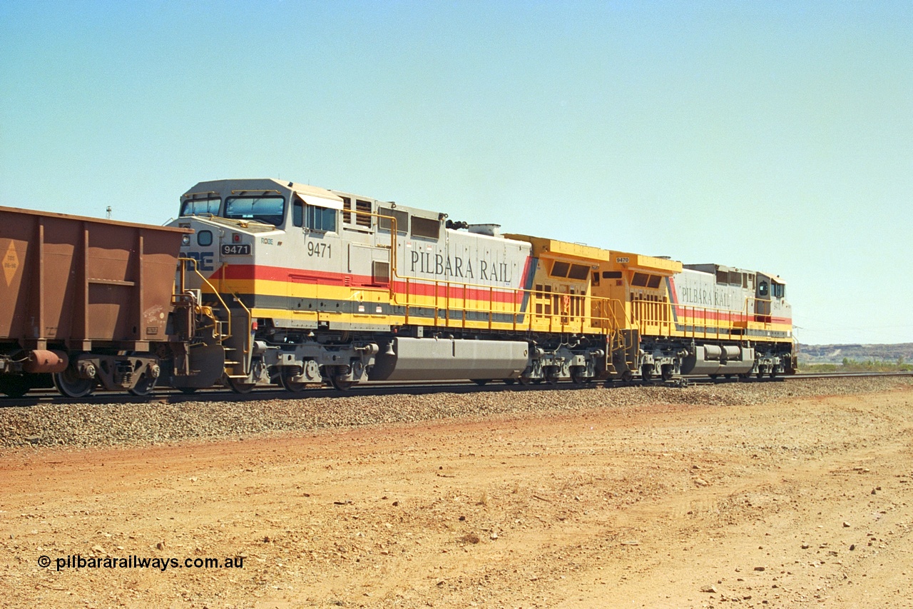 240-34
Seven Mile, trailing view of a loaded train heading for Parker Point behind a pair of Pilbara Rail, Robe River owned, General Electric built Dash 9-44CW units 9470 serial 53455 and 9471 serial 53456. These and sister unit 9472 were the first painted in the Pilbara Rail livery. 31st August 2002.
Keywords: 9470;9471;GE;Dash-9-44CW;53455;53456