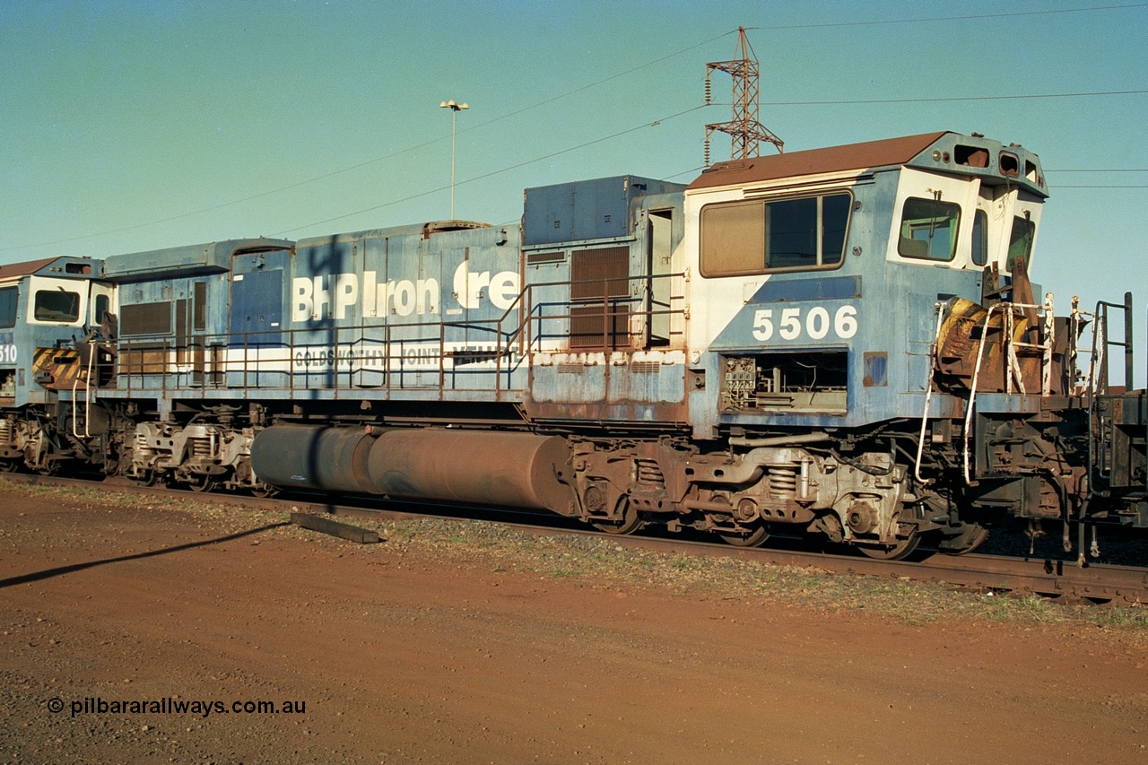 241-05
Nelson Point, Goninan GE rebuild C36-7M unit 5506 serial 4839-01 / 87-071 is in the process of being removed from site bound for Asset Kinetics in Maddington, Perth. 5506 was rebuilt from NSW AE Goodwin built C636 ALCo number 5455 serial G6012-04 and was delivered in Mt Newman orange livery and originally named 'Mt Whaleback', after repainting into BHP blue was named 'Ethel Creek', then finally 'Mt Goldsworthy'. June 2002.
Keywords: 5506;Goninan;GE;C36-7M;4839-01/87-071;rebuild;AE-Goodwin;ALCo;C636;5455;G6012-4;