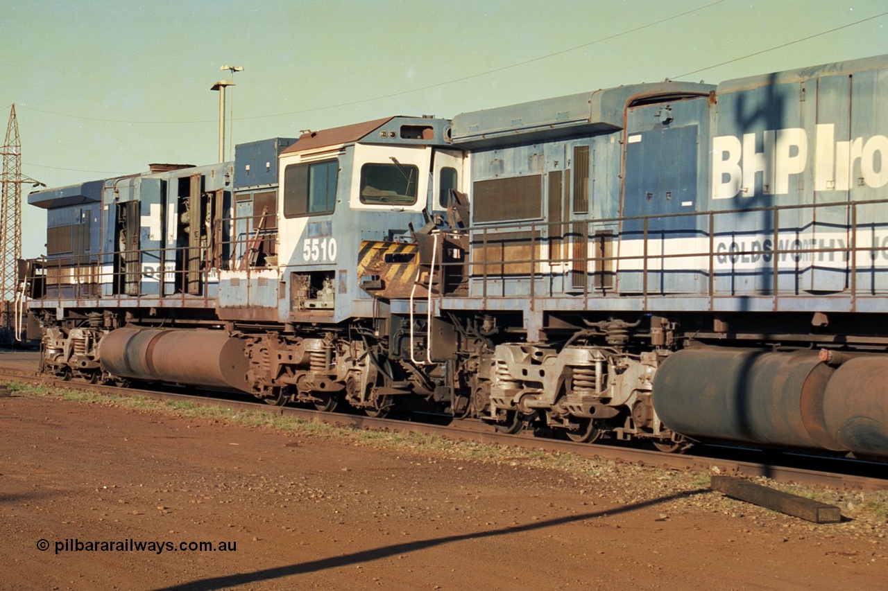 241-06
Nelson Point, Goninan GE rebuild C36-7M units 5506 serial 4839-01 / 87-071 and 5510 serial 4839-07 / 87-075 are in the process of being removed from site bound for Asset Kinetics in Maddington, Perth. This view from the radiator of 5506 looking at 5510 shows the difference in the Dash 7 radiator on 5506 and the Dash 8 radiator fitted to 5510 following collision repairs. June 2002.
Keywords: 5506;Goninan;GE;C36-7M;4839-01/87-071;rebuild;AE-Goodwin;ALCo;C636;5455;G6012-4;