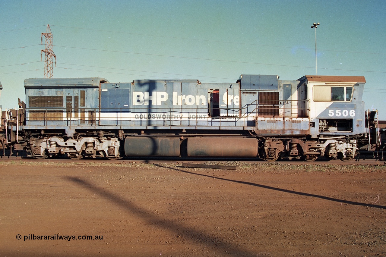 241-18
Nelson Point, Goninan GE rebuild C36-7M unit 5506 serial 4839-01 / 87-071 is in the process of being removed from site bound for Asset Kinetics in Maddington, Perth. Drivers side view with hood door open, Goldsworthy Joint Venture signage. 5506 was rebuilt from NSW AE Goodwin built C636 ALCo number 5455 serial G6012-04 and was delivered in Mt Newman orange livery and originally named 'Mt Whaleback', after repainting into BHP blue was named 'Ethel Creek', then finally 'Mt Goldsworthy'. June 2002.
Keywords: 5506;Goninan;GE;C36-7M;4839-01/87-071;rebuild;AE-Goodwin;ALCo;C636;5455;G6012-4;