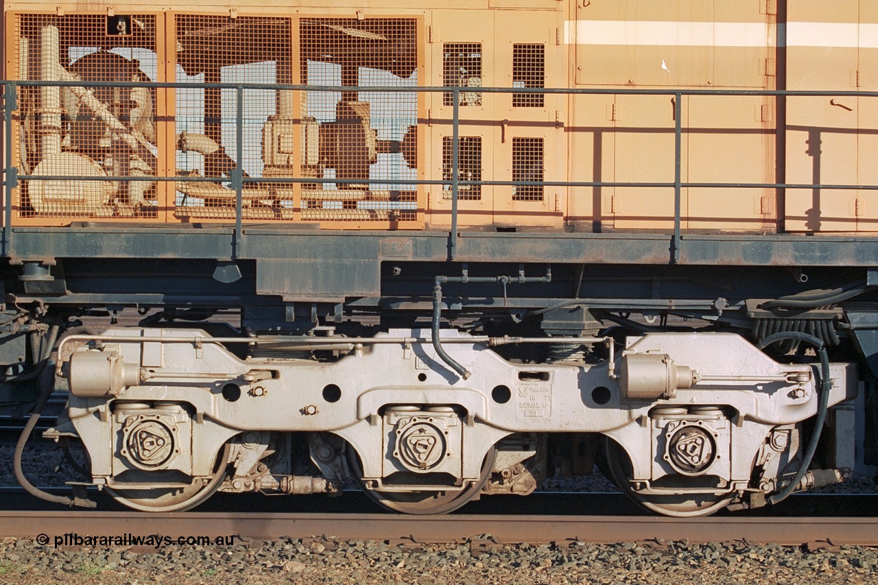 241-21
Nelson Point, Mt Newman Mining's last in-service ALCo M636 unit 5499 serial C6096-4 built by Comeng NSW sits awaiting partial dismantling before being sent by road to Rail Heritage WA's museum at Bassendean, Perth for preservation. Drivers side view of the radiator section and bogie. June 2002.
Keywords: 5499;Comeng-NSW;ALCo;M636;C6096-4;