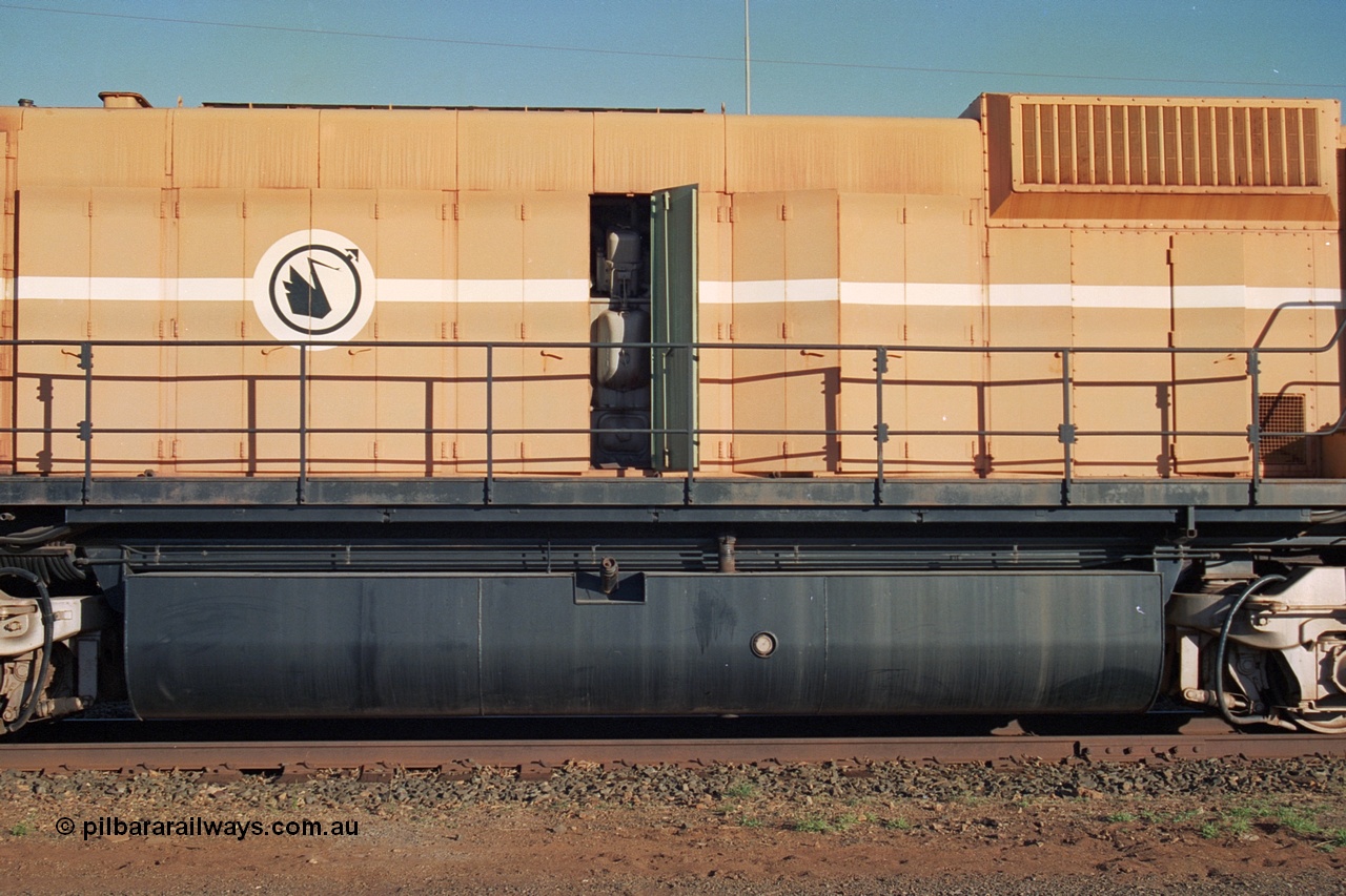 241-22
Nelson Point, Mt Newman Mining's last in-service ALCo M636 unit 5499 serial C6096-4 built by Comeng NSW sits awaiting partial dismantling before being sent by road to Rail Heritage WA's museum at Bassendean, Perth for preservation. Drivers side view of the engine hood and fuel tank. June 2002.
Keywords: 5499;Comeng-NSW;ALCo;M636;C6096-4;