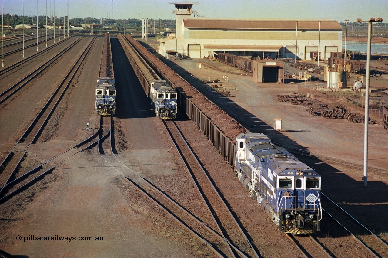 241-30
Nelson Point, Car Dumper 2 holding roads with Yard Control tower and Ore Car Repair Shop in the background as three loaded ore rakes behind a pair of CM40-8M units on each wait their turn through the dumper to discharge. June 2002.
Keywords: 5649;Goninan;GE;CM40-8M;8412-07/93-140;rebuild;AE-Goodwin;ALCo;M636C;5473;G6047-5;