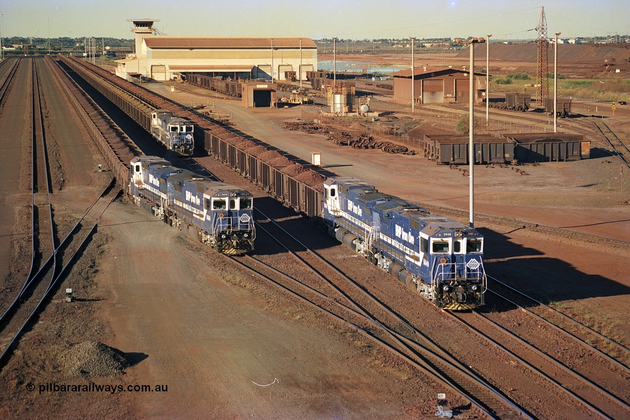 241-35
Nelson Point, Car Dumper 2 holding roads with Yard Control tower and Ore Car Repair Shop in the background as two loaded ore rakes behind pairs of CM40-8M units on each wait their turn through the dumper to discharge as 5660 'Kure' serial 8412-05 / 94-151 and 5657 'Fukuyama' drag their loaded train towards the dumper to discharge . June 2002.
Keywords: 5660;Goninan;GE;CM40-8M;8412-05/94-151;rebuild;AE-Goodwin;ALCo;M636C;5478;G6047-10;