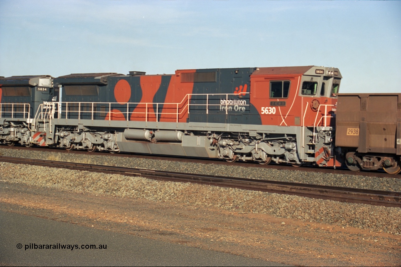 243-07
Nelson Point departure yard, BHP Billiton's CM39-8 unit 5630 'Zeus' serial 5831-09 / 88-079 and built new by Goninan trails CM40-8M unit 5634 both in the new 'earth' or 'bubble' livery as they head up an empty train waiting departure time. August 2003.
Keywords: 5630;Goninan;GE;CM39-8;5831-09/88-079;