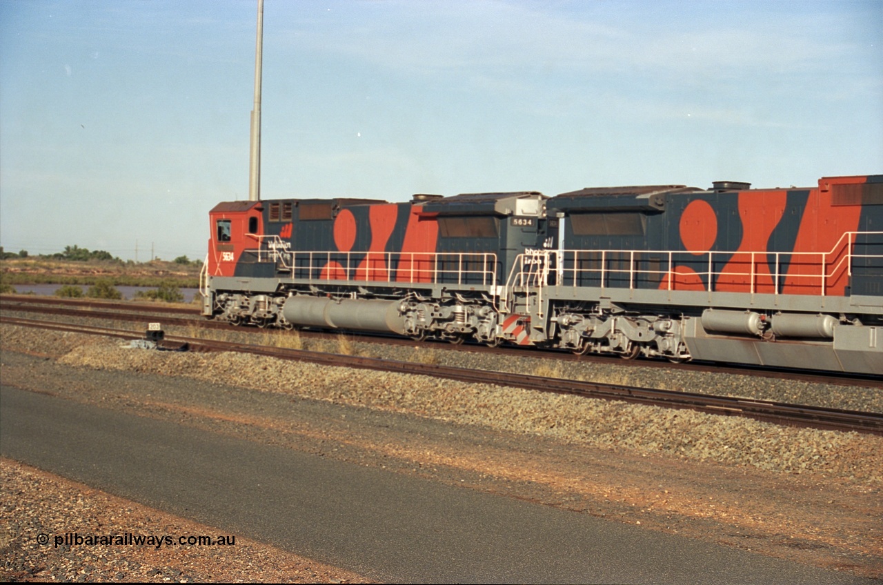 243-08
Nelson Point departure yard, BHP Billiton's CM40-8M unit 5634 'Boodarie' a Goninan WA GE rebuild unit serial 8151-07 / 91-120 in the new 'earth' or 'bubble' livery as it heads up an empty train waiting departure time. August 2003.
Keywords: 5634;Goninan;GE;CM40-8M;8151-07/91-120;rebuild;AE-Goodwin;ALCo;C636;5457;G6027-1;