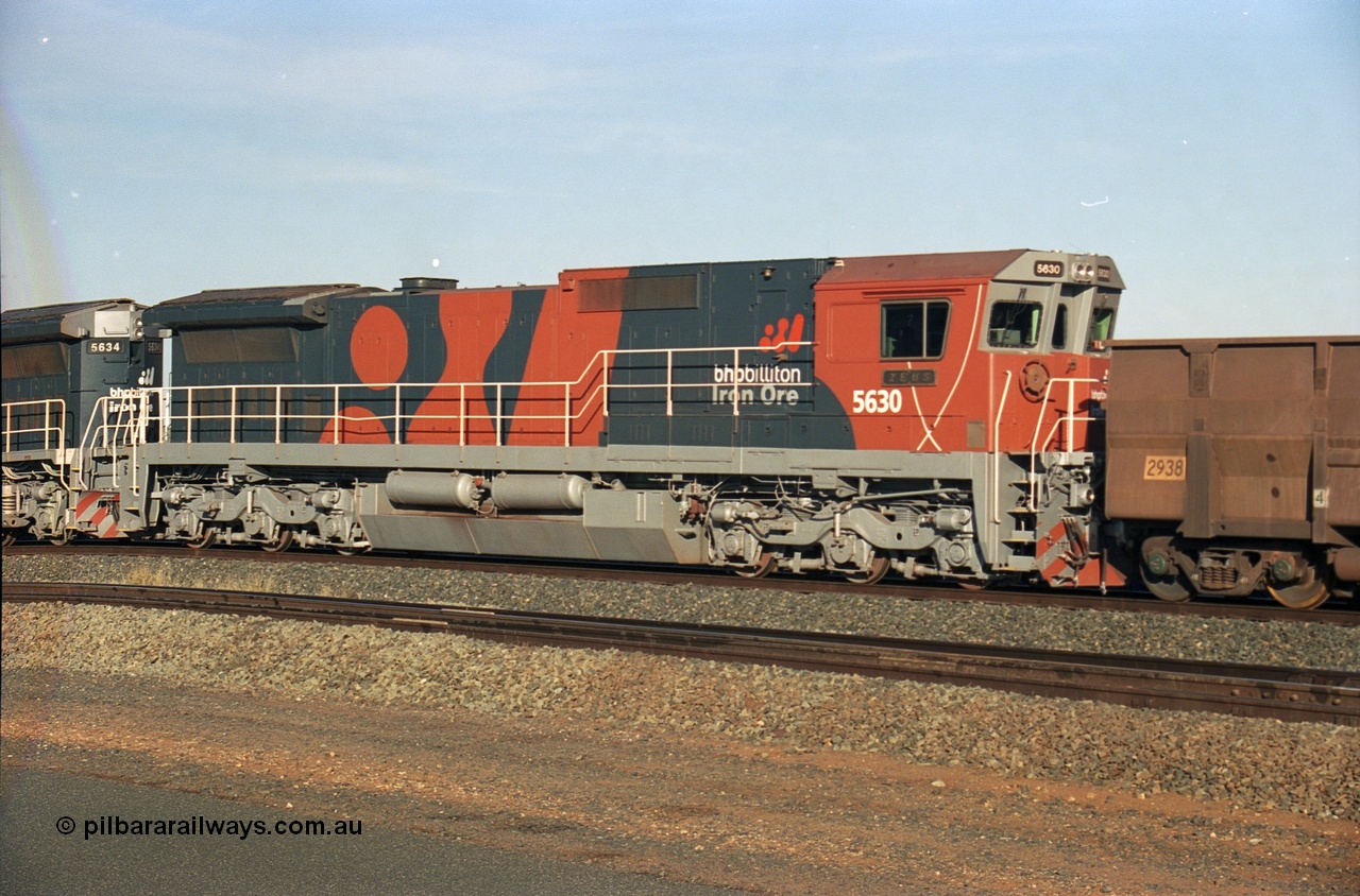 243-10
Nelson Point departure yard, BHP Billiton's CM39-8 unit 5630 'Zeus' serial 5831-09 / 88-079 and built new by Goninan trails CM40-8M unit 5634 both in the new 'earth' or 'bubble' livery as they head up an empty train waiting departure time. August 2003.
Keywords: 5630;Goninan;GE;CM39-8;5831-09/88-079;