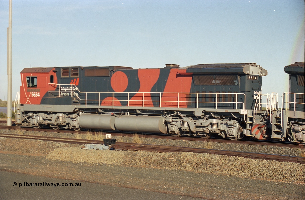 243-13
Nelson Point departure yard, BHP Billiton's CM40-8M unit 5634 'Boodarie' a Goninan WA GE rebuild unit serial 8151-07 / 91-120 in the new 'earth' or 'bubble' livery as it heads up an empty train waiting departure time. August 2003.
Keywords: 5634;Goninan;GE;CM40-8M;8151-07/91-120;rebuild;AE-Goodwin;ALCo;C636;5457;G6027-1;