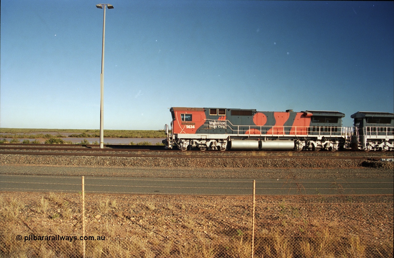 243-15
Nelson Point departure yard, BHP Billiton's CM40-8M unit 5634 'Boodarie' a Goninan WA GE rebuild unit serial 8151-07 / 91-120 in the new 'earth' or 'bubble' livery as it heads up an empty train waiting departure time. August 2003.
Keywords: 5634;Goninan;GE;CM40-8M;8151-07/91-120;rebuild;AE-Goodwin;ALCo;C636;5457;G6027-1;