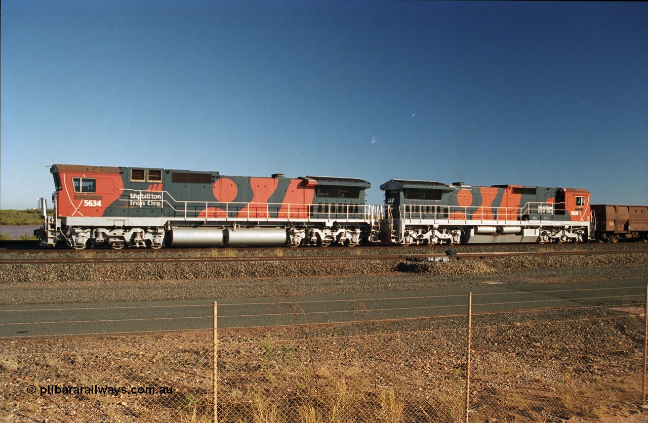 243-16
Nelson Point departure yard, BHP Billiton's CM40-8M unit 5634 'Boodarie' a Goninan WA GE rebuild unit serial 8151-07 / 91-120 in the new 'earth' or 'bubble' livery as it heads up an empty train waiting departure time. August 2003.
Keywords: 5634;Goninan;GE;CM40-8M;8151-07/91-120;rebuild;AE-Goodwin;ALCo;C636;5457;G6027-1;