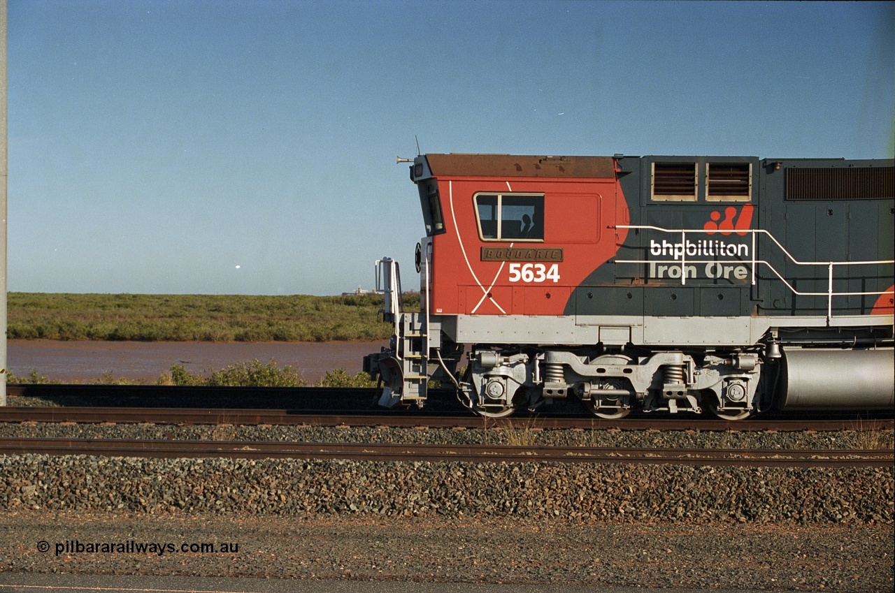 243-17
Nelson Point departure yard, BHP Billiton's CM40-8M unit 5634 'Boodarie' a Goninan WA GE rebuild unit serial 8151-07 / 91-120 in the new 'earth' or 'bubble' livery as it heads up an empty train waiting departure time. August 2003.
Keywords: 5634;Goninan;GE;CM40-8M;8151-07/91-120;rebuild;AE-Goodwin;ALCo;C636;5457;G6027-1;