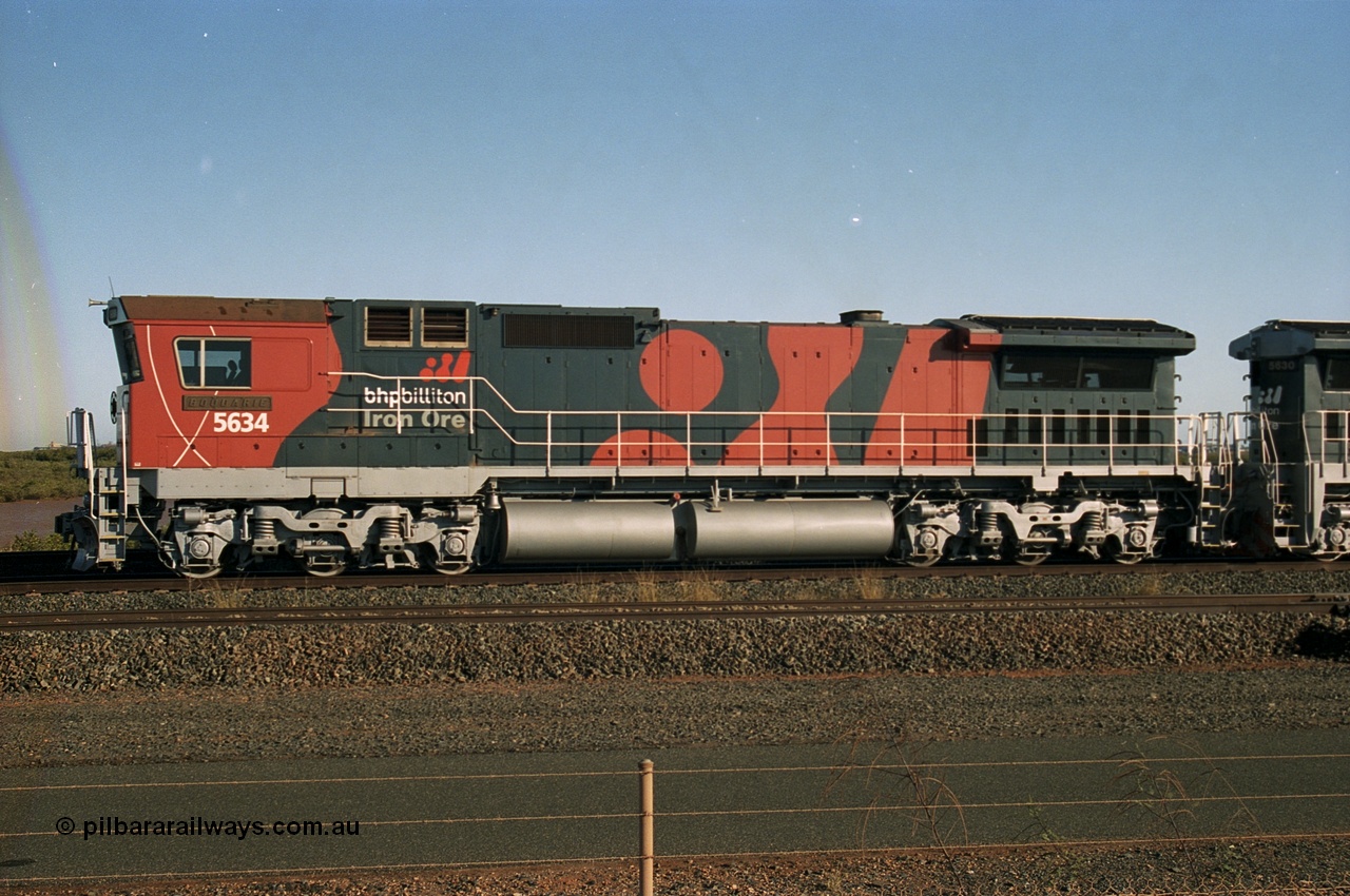 243-22
Nelson Point departure yard, BHP Billiton's CM40-8M unit 5634 'Boodarie' a Goninan WA GE rebuild unit serial 8151-07 / 91-120 in the new 'earth' or 'bubble' livery as it heads up an empty train waiting departure time. August 2003.
Keywords: 5634;Goninan;GE;CM40-8M;8151-07/91-120;rebuild;AE-Goodwin;ALCo;C636;5457;G6027-1;