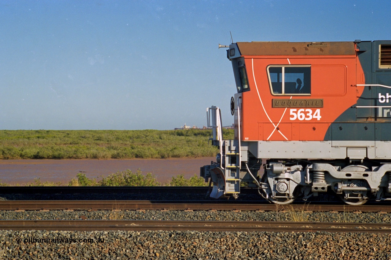 243-36
Nelson Point departure yard, BHP Billiton's CM40-8M unit 5634 'Boodarie' a Goninan WA GE rebuild unit serial 8151-07 / 91-120 in the new 'earth' or 'bubble' livery as it heads up an empty train waiting departure time. August 2003. The view to the left is much changed as FMG now has five berths along with Roy Hill and BHP Harriet Point.
Keywords: 5634;Goninan;GE;CM40-8M;8151-07/91-120;rebuild;AE-Goodwin;ALCo;C636;5457;G6027-1;