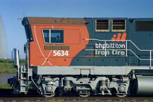 243-30
Nelson Point departure yard, BHP Billiton's CM40-8M unit 5634 'Boodarie' a Goninan WA GE rebuild unit serial 8151-07 / 91-120 in the new 'earth' or 'bubble' livery as it heads up an empty train waiting departure time. August 2003.
Keywords: 5634;Goninan;GE;CM40-8M;8151-07/91-120;rebuild;AE-Goodwin;ALCo;C636;5457;G6027-1;