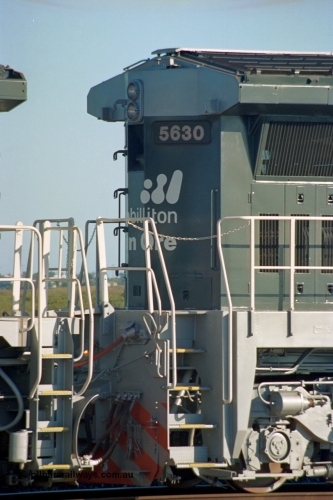 243-33
Nelson Point departure yard, no. 2 end view of BHP Billiton's CM39-8 unit 5630 'Zeus' serial 5831-09 / 88-079 and built new by Goninan WA in the new 'earth' or 'bubble' livery as it trails an empty train waiting departure time. August 2003.
Keywords: 5630;Goninan;GE;CM39-8;5831-09/88-079;