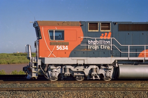 243-37
Nelson Point departure yard, BHP Billiton's CM40-8M unit 5634 'Boodarie' a Goninan WA GE rebuild unit serial 8151-07 / 91-120 in the new 'earth' or 'bubble' livery as it heads up an empty train waiting departure time. August 2003.
Keywords: 5634;Goninan;GE;CM40-8M;8151-07/91-120;rebuild;AE-Goodwin;ALCo;C636;5457;G6027-1;