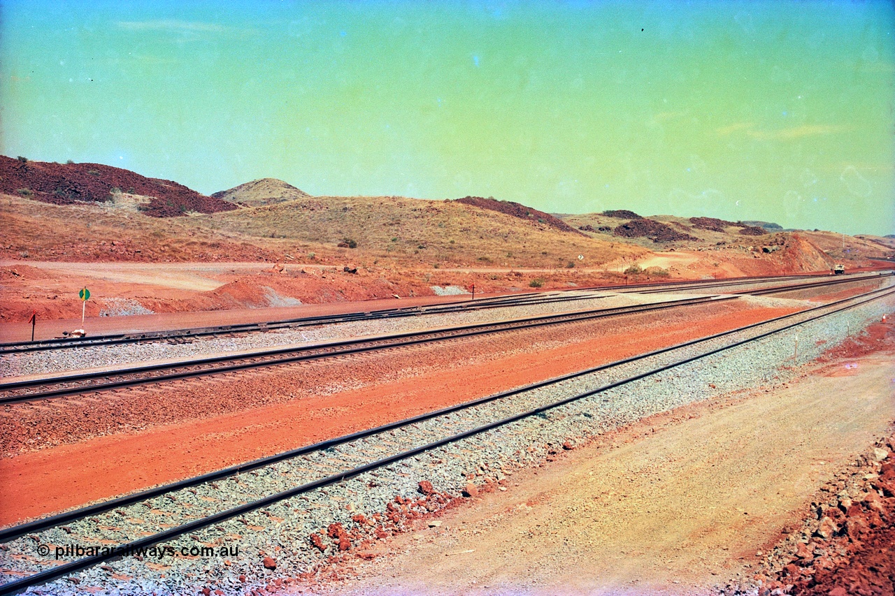 246-02
Cape Lambert, view of the then new extension to the south for the West Angelas mine was coming on stream, the siding furthest from the camera will become a compressor waggon holding road while the original line or Mainline is the second from the camera, with the car dumper one Empty Car line closest, and what becomes the car dumper two Loaded Car line is third. 22nd May 2002.
