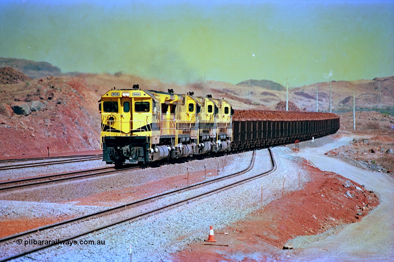 246-16
Cape Lambert, yard view of the then new extension to the south for the West Angelas mine was coming on stream as a Robe River loaded Deepdale train arrives on the main behind the standard quad Dash 8 power with 202 waggons. 9414 which is a Goninan WA ALCo to GE rebuild CM40-8M with serial 8206-11 / 91-124 from November 1991 and was originally an AE Goodwin built M636 ALCo built new for Robe in December 1971 and numbered 262.005, later numbered 1714. 22nd May 2002.
Keywords: 9414;Goninan;GE;CM40-8M;8206-11/91-124;rebuild;AE-Goodwin;ALCo;M636;G6060-5;