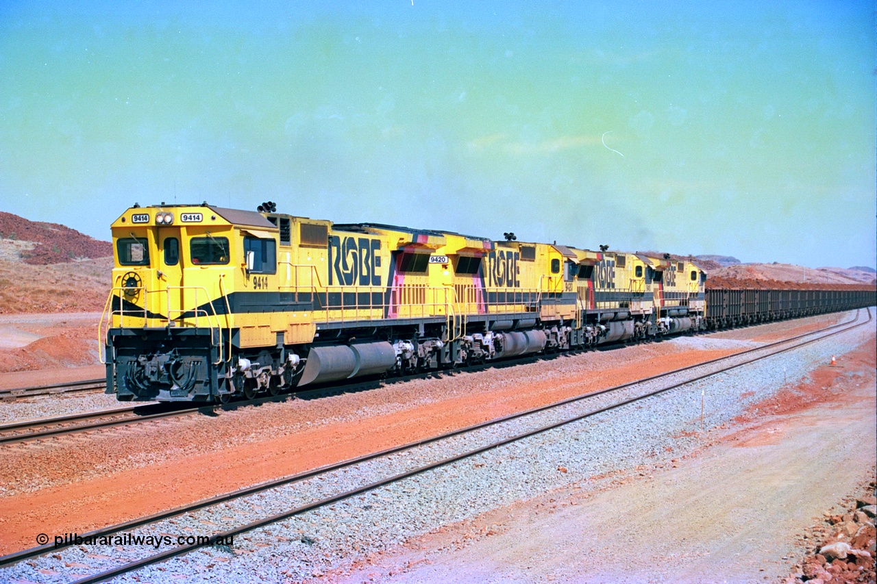 246-20
Cape Lambert, a Robe River loaded Deepdale train arrives on the main behind the standard quad Dash 8 power with 202 waggons. 9414 which is a Goninan WA ALCo to GE rebuild CM40-8M with serial 8206-11 / 91-124 from November 1991 riding on Dofasco bogies and was originally an AE Goodwin built M636 ALCo built new for Robe in December 1971 and numbered 262.005, later numbered 1714. 22nd May 2002.
Keywords: 9414;Goninan;GE;CM40-8M;8206-11/91-124;rebuild;AE-Goodwin;ALCo;M636;G6060-5;