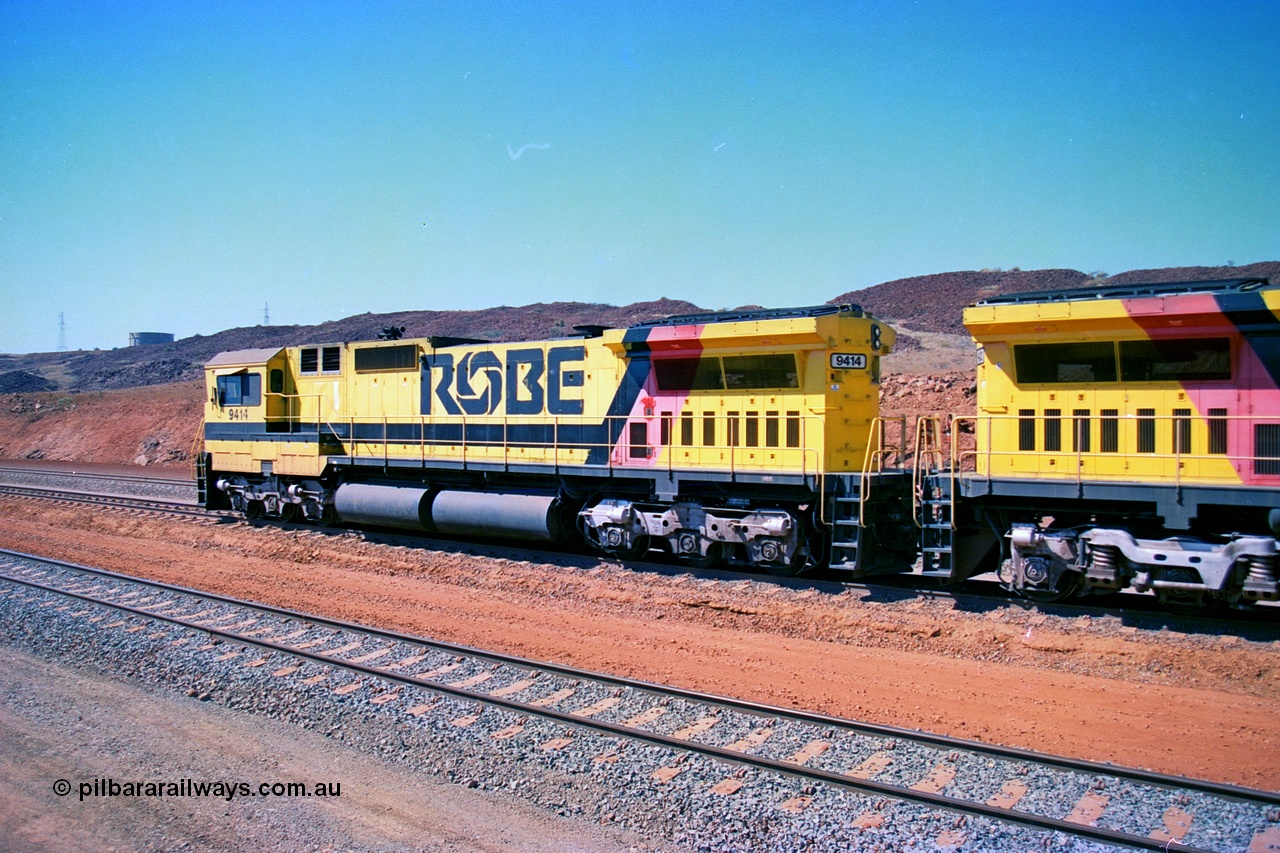 246-22
Cape Lambert, Robe River locomotive 9414 which is a Goninan WA ALCo to GE rebuild CM40-8M with serial 8206-11 / 91-124 from November 1991 riding on Dofasco bogies and was originally an AE Goodwin built M636 ALCo built new for Robe in December 1971 and numbered 262.005, later numbered 1714. Everything below the frame is ALCo while above is GE and Pilbara Cab. 22nd May 2002.
Keywords: 9414;Goninan;GE;CM40-8M;8206-11/91-124;rebuild;AE-Goodwin;ALCo;M636;G6060-5;