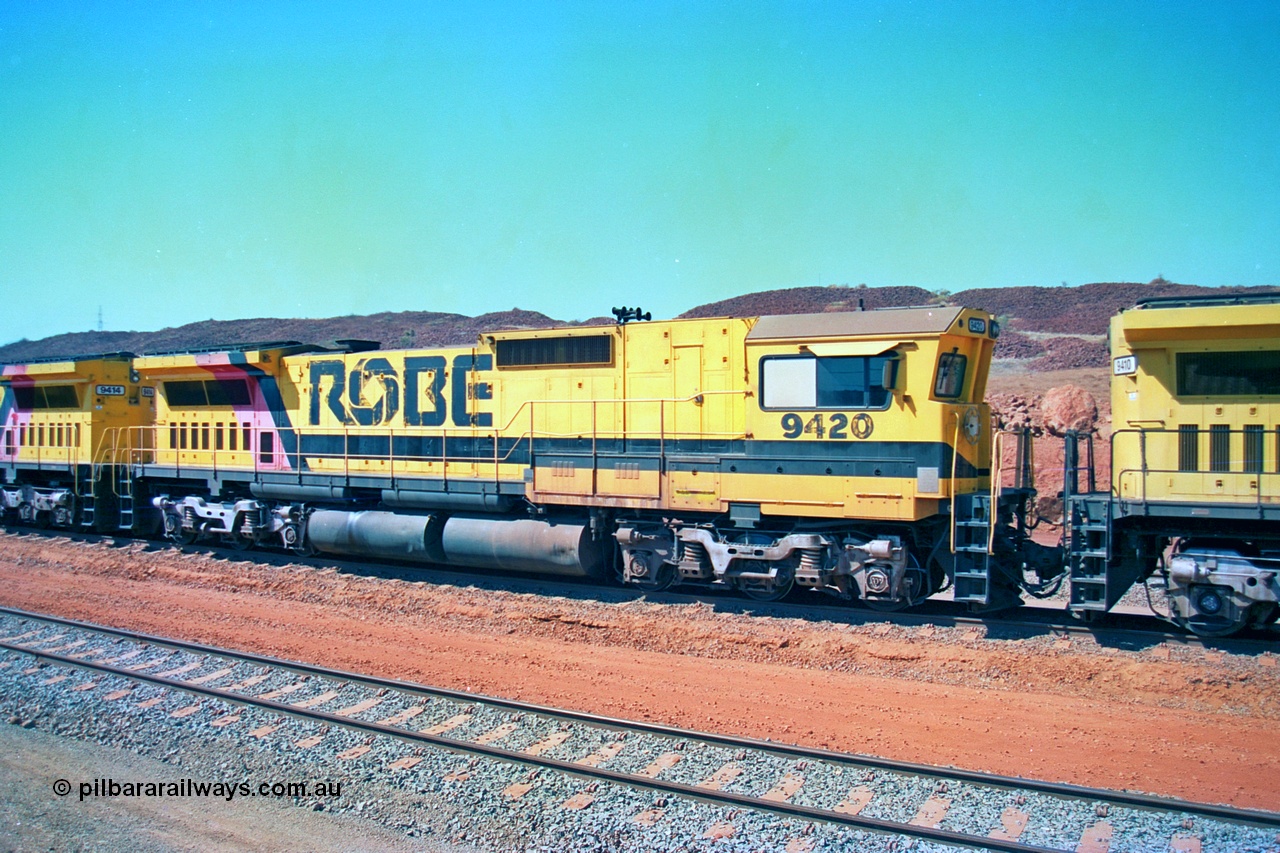 246-23
Cape Lambert, Robe River locomotive 9420 which is a Goninan WA ALCo to GE rebuild CM40-8M with serial 8109-03 / 91-119 from March 1991 riding on Hi-Ad bogies and was originally an ALCo Schenectady built C630 serial 3486-4 and built new for Chesapeake & Ohio (USA) as their 2103. It is one of four C630 ALCo units purchased in 1974 and delivered to Robe in January 1975. Everything below the frame is ALCo while above is GE and Pilbara Cab. 22nd May 2002.
Keywords: 9420;Goninan;GE;CM40-8M;8109-03/91-119;rebuild;ALCo;C630;3486-4;C+O;2103;