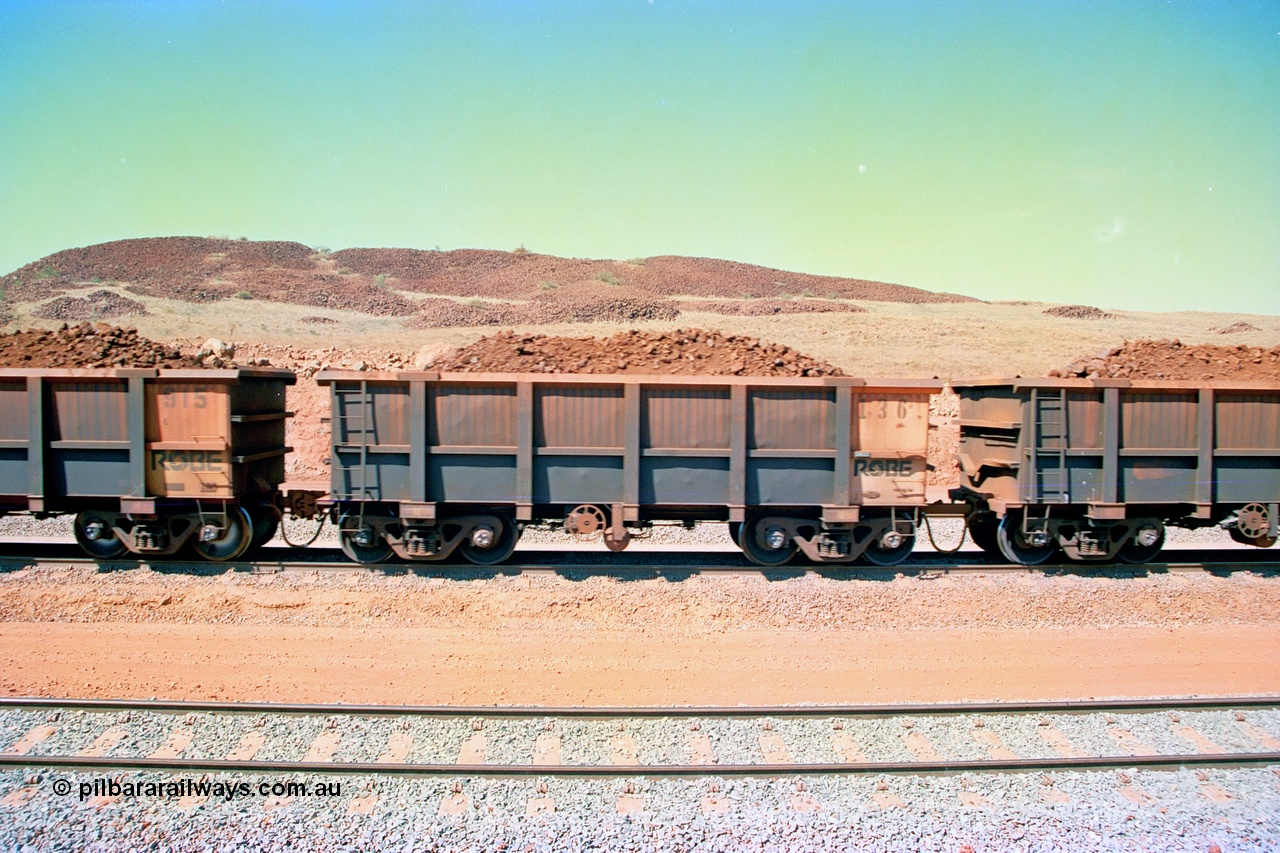 246-32
Cape Lambert, a Robe River loaded Deepdale train on the mainline with waggon 136 which is from the original order for 285 waggons from Nippon Sharyo Japan. The ore is a ROM product and will be dumped over the gyratory crusher to be correctly sized. 22nd May 2002.
Keywords: 136;Nippon-Sharyo-Japan;J-series;