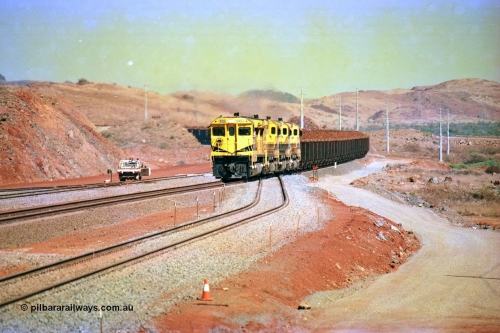 246-13
Cape Lambert, yard view of the then new extension to the south for the West Angelas mine was coming on stream as a Robe River loaded Deepdale train arrives on the main behind the standard quad Dash 8 power with 202 waggons. 9414 which is a Goninan WA ALCo to GE rebuild CM40-8M with serial 8206-11 / 91-124 from November 1991 and was originally an AE Goodwin built M636 ALCo built new for Robe in December 1971 and numbered 262.005, later numbered 1714. 22nd May 2002.
Keywords: 9414;Goninan;GE;CM40-8M;8206-11/91-124;rebuild;AE-Goodwin;ALCo;M636;G6060-5;