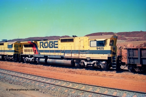 246-25
Cape Lambert, Robe River locomotive 9425 which is a Goninan WA ALCo to GE rebuild CM40-8M with serial 6266-8 / 89-85 from August 1989 riding on Hi-Ad bogies and was originally an AE Goodwin built M636 ALCo serial C-6041-4 and built new for Mt Newman Mining (later BHP Iron Ore) in April 1970 and numbered 5468, sold to Robe and delivered by road 17th August 1982. Everything below the frame is ALCo while above is GE and Pilbara Cab. 22nd May 2002.
Keywords: 9425;Goninan;GE;CM40-8M;6266-8/89-85;rebuild;AE-Goodwin;ALCo;M636;G-6041-4;