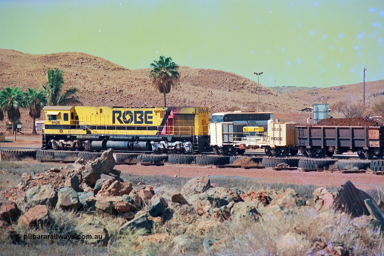 247-03
Cape Lambert, Robe River's 9426 a Comeng WA rebuild from ALCo Schenectady NY model C636 serial 3499-3 originally built in January 1968 for Pennsylvania as #6332, Penn Central 6332 and finally Conrail 6782. Purchased in 1986 and rebuilt by Comeng WA into C636R before delivery to Robe in November 1986. This loco also went on to become DR 8401 for construction of FMG's railway in 2007-08. Seen here in the South Yard waiting to drag a loaded rake down to the car dumper. Approximate location of train is [url=https://goo.gl/maps/tRtaJxMULpjBhtqa8]here[/url]. 22nd May 2002.
Keywords: 9426;Comeng-WA;C636R;WA143-1;rebuild;ALCo;Schenectady-NY;C636;Conrail;6782;3499-3;